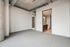Modern apartment interior with sleek exposed ductwork, cozy carpeted floors, and access to a stylish bathroom featuring contemporary fixtures.