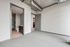 Modern apartment interior featuring a bright, spacious room with a neutral color palette, stylish exposed ductwork, and an en-suite bathroom with sleek cabinetry.