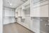 Spacious walk-in closet with sleek shelving and ample hanging space, perfect for modern living.