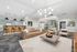 Contemporary chic living space featuring elegant lighting, stylish bar seating, and a cozy seating area with a modern aesthetic.