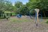 Charming outdoor pet play area with agility equipment and lush greenery, perfect for active pets and relaxing afternoon strolls.