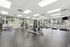 Spacious and modern gym with state-of-the-art fitness machines and bright natural lighting.