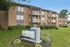 Inviting brick apartment building with private balconies and lush landscaping at the peaceful reNEW Foundry Centre.