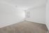 Bright and spacious bedroom with fresh neutral tones and plush carpeting, perfect for a serene retreat.