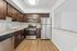 Modern kitchen with stainless steel appliances, rich wood cabinetry, and elegant granite countertops.
