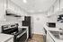 Modern kitchen with sleek stainless steel appliances, white cabinetry, and stylish subway tile backsplash.