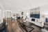 Modern living room with elegant decor, featuring a spacious sofa, stylish dining area, and sleek kitchen design.
