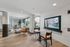Chic lounge area in modern apartment with stylish seating, elegant decor, and floor-to-ceiling windows providing natural light.