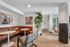 Contemporary apartment lobby with stylish brown leather seating, elegant artwork, and vibrant indoor plants creating a welcoming atmosphere.