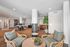 Chic communal lounge area featuring stylish seating, lush greenery, and modern decor perfect for relaxation.