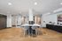 Elegant communal area with modern seating, polished wooden floors, and vibrant artwork, perfect for gatherings.