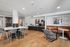 Contemporary communal lounge featuring stylish seating, modern decor, and vibrant wall art in a cozy environment.
