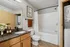 Elegant bathroom with granite countertop, decorative wall art, and in-unit laundry facilities, offering modern convenience and style.