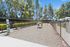 Charming fenced dog park with agility equipment surrounded by lush trees, perfect for pet-friendly apartments.