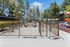 Inviting dog park with secure fencing, benches, and vibrant playground nearby, perfect for a pet-friendly community.