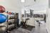 Contemporary fitness center equipped with exercise bikes, treadmills, kettlebells, and yoga mats, perfect for an energetic workout.