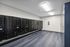 Modern mailroom with sleek black mailboxes and bright overhead lighting, ensuring secure and convenient package delivery.