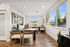Bright office space featuring modern furnishings, large windows with scenic views, and sleek wooden flooring creating a welcoming atmosphere.
