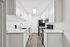 Sleek modern kitchen with white cabinetry, stainless steel appliances, and elegant wood flooring, offering a bright and inviting space.