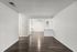 Bright and spacious living area with modern hardwood flooring and neutral walls, perfect for personalized styling.