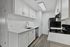 Modern kitchen with sleek stainless steel appliances, elegant white cabinetry, and spacious marble countertops.