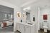 Chic apartment interior showcasing a modern bathroom vanity, elegant bedroom with natural light, and stylish decor.