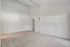 Bright and spacious empty room with plush carpet and high ceilings, ready for personalization.