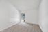 Bright and airy empty room with plush carpet, large window, and neutral walls, perfect for customization.
