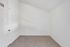 Bright and inviting empty room with plush carpet and spotless white walls, offering a blank canvas for customization.