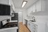 Sleek modern kitchen with white cabinetry, stainless steel appliances, and elegant countertops.