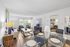 Bright and inviting living room with modern decor, featuring cozy seating, a stylish coffee table, and an elegant dining area, perfect for entertaining.