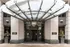 Elegant apartment entrance with modern glass canopy and stylish architectural elements.