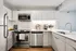 Modern kitchen with sleek stainless steel appliances, elegant white cabinetry, and a stylish faucet accentuating a functional and inviting space.