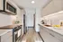 Modern, sleek kitchen with stainless steel appliances, elegant wooden cabinetry, and a spacious layout perfect for culinary enthusiasts.
