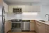 Modern kitchen with sleek stainless steel appliances, stylish wood cabinetry, and elegant countertops.