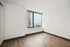 Bright and airy room with stunning city and ocean views, featuring elegant wood flooring and abundant natural light.