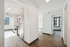 Modern apartment interior showcasing a sleek kitchen with stainless steel appliances, bright natural light, and elegant hardwood floors.