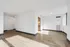 Bright and open living space with modern hardwood floors and abundant natural light, perfect for stylish living.