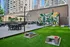 Vibrant urban rooftop patio featuring modern seating, colorful wall art, and lush greenery, perfect for social gatherings and relaxation.