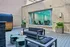 Chic outdoor patio with modern seating, stylish geometric tables, and vibrant plants, ideal for relaxation and entertaining.