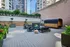 Modern apartment terrace with stylish seating, greenery, and a unique outdoor sauna, set against an urban skyline.