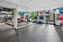 Modern fitness center with state-of-the-art equipment, mirrored walls, and vibrant exercise balls, offering a dynamic workout environment.