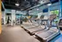 Modern fitness center boasting state-of-the-art treadmills, ample natural light, and mirrored walls for an invigorating workout experience.