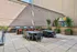 Modern outdoor patio featuring stylish dining tables, vibrant seating, and state-of-the-art grills, perfect for gatherings and relaxation.