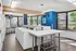 Bright and inviting laundry room with modern machines, large windows, and vibrant decor.