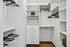 Elegant walk-in closet with spacious shelving and sleek storage solutions, perfect for organizing luxury apparel.
