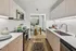 Modern kitchen with sleek cabinetry, stainless steel appliances, and a cozy dining area offering a stylish and functional living space.