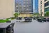 Chic urban outdoor terrace with stylish seating areas, lush greenery, and a modern shaded pergola, perfect for relaxation and social gatherings.