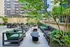 Chic outdoor terrace with modern seating, lush greenery, and urban views, perfect for relaxation and social gatherings.