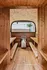 Cozy wooden sauna room featuring sleek benches and a modern heater, offering a tranquil escape.